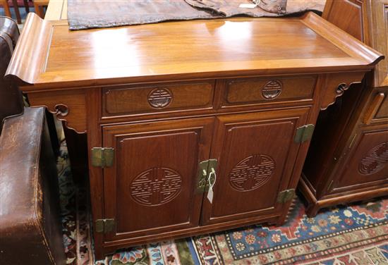 A Chinese hardwood cupboard, fitted two drawers W.115cm